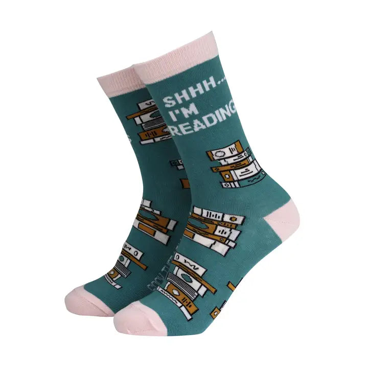 Teal socks with book design and 'SHHH. I'M READING' text on a white background