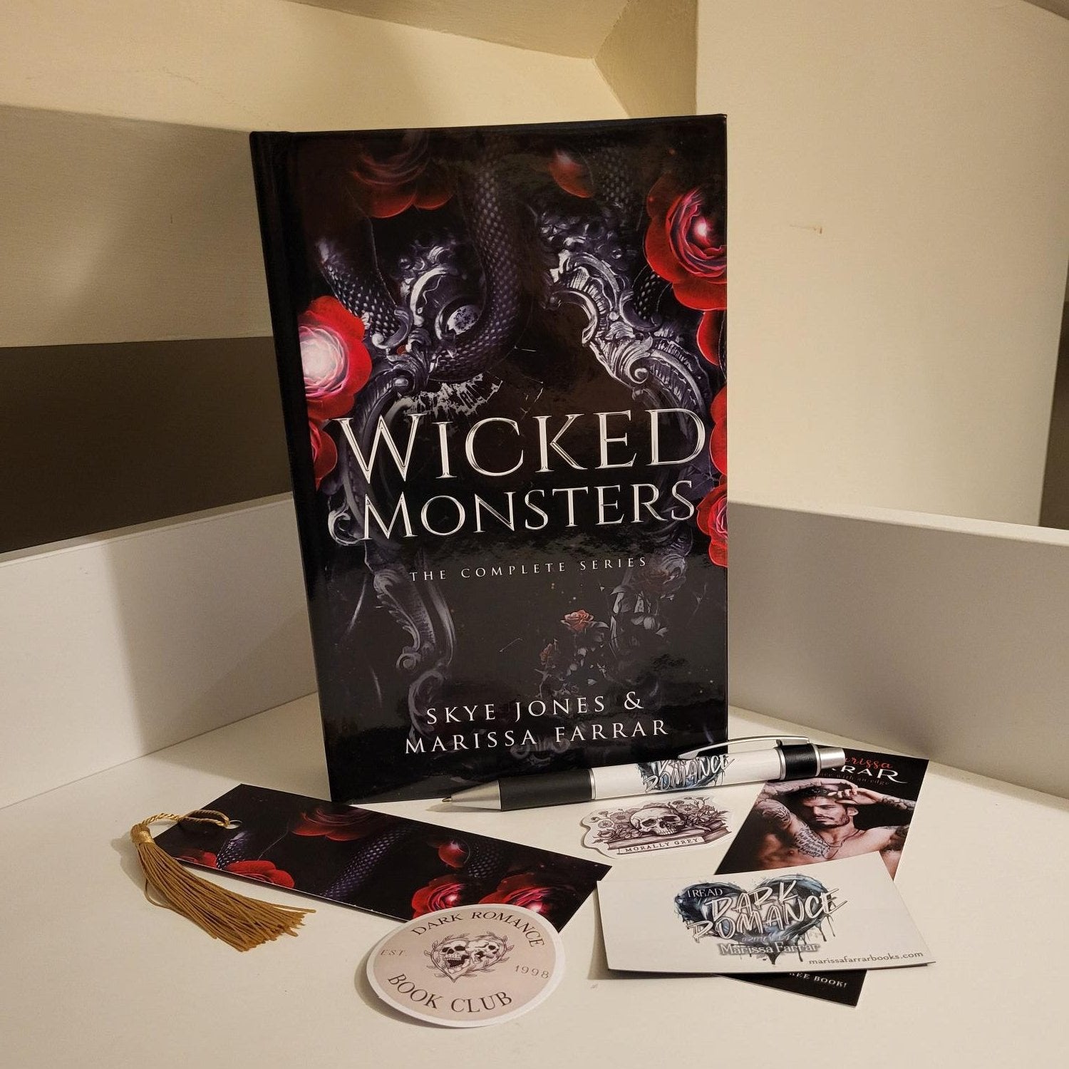 Hardback of Wicked Monsters and accompanying swag