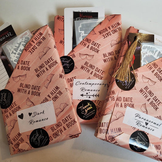 Three wrapped 'Blind Date with a Book' books showing genres of paranormal romance, dark romance, and contemporary romance.