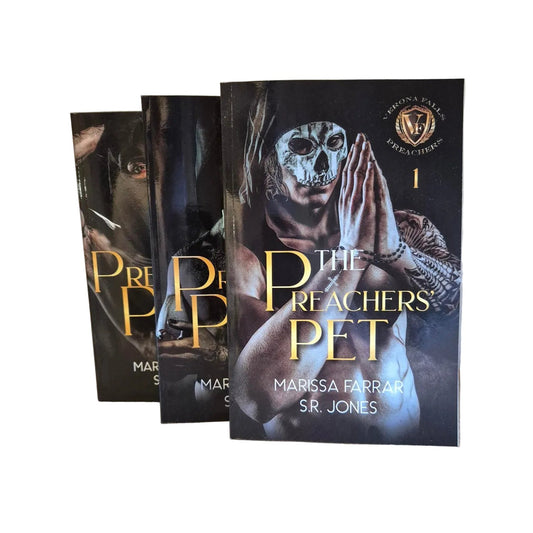 Two books titled 'Preacher's Pet' by Marissa Farrow and S.R. Jones on a wooden surface.