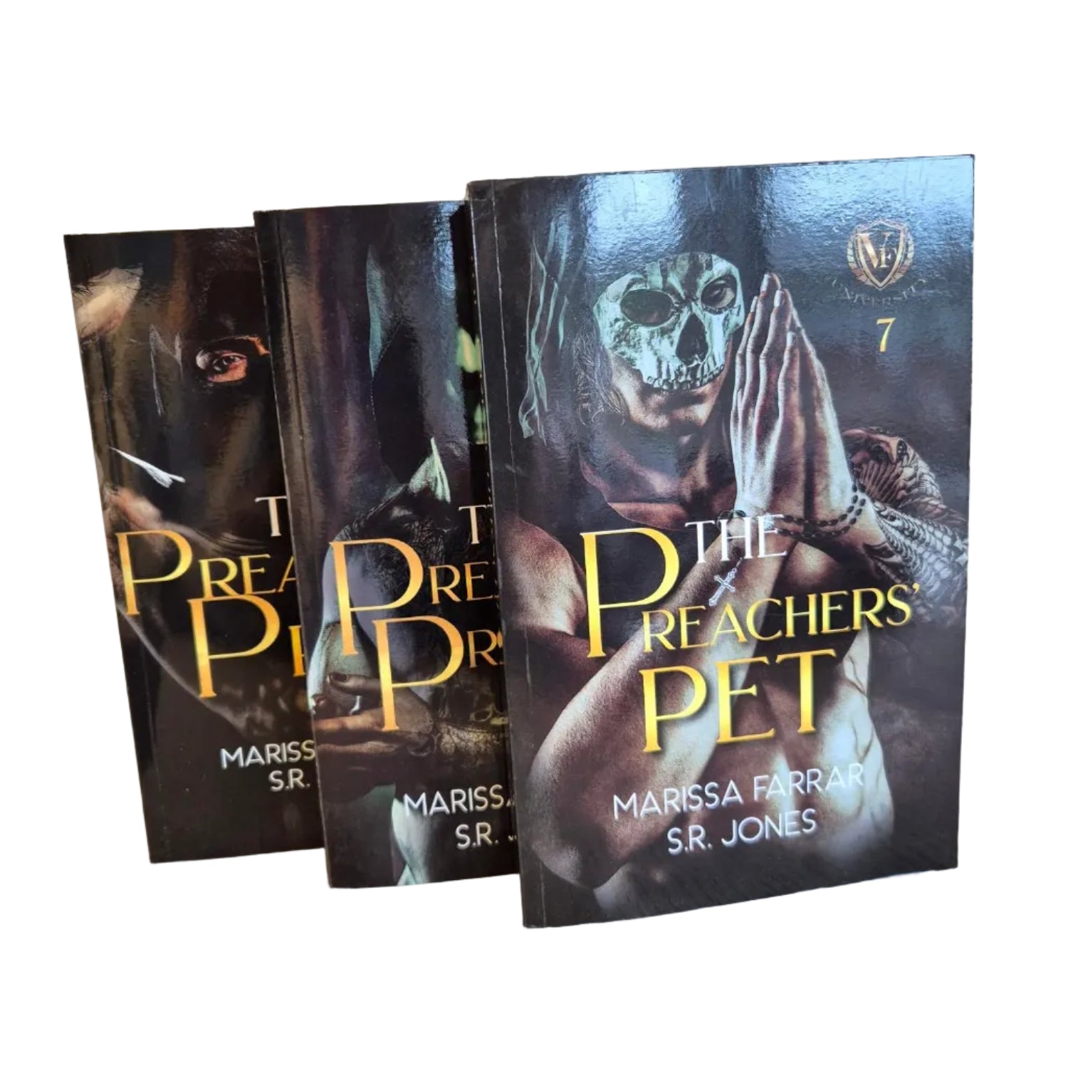 Three books titled 'The Preacher's Pet' by Marissa Farrar and S. R. Jones on a wooden surface.