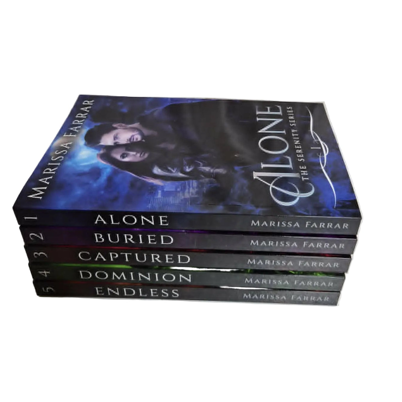 Stack of books titled 'Alone', 'Buried', 'Captured', 'Dominion', and 'Endless' by Marissa Farrar on a white fabric background.