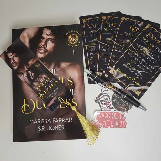 The paperback of The Devils and The Duchess with a matching bookmark, character cards, pen and stickers