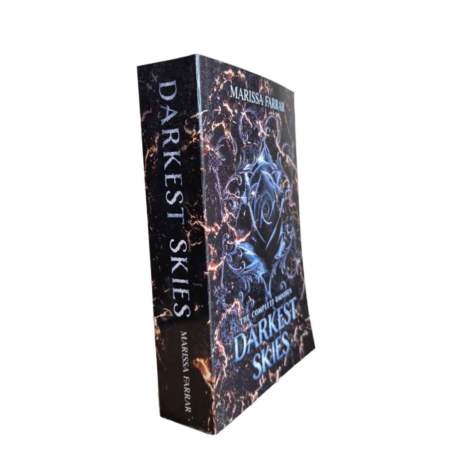 Book titled 'Darkest Skies' by Marissa Fierro on a wooden surface with a plain background