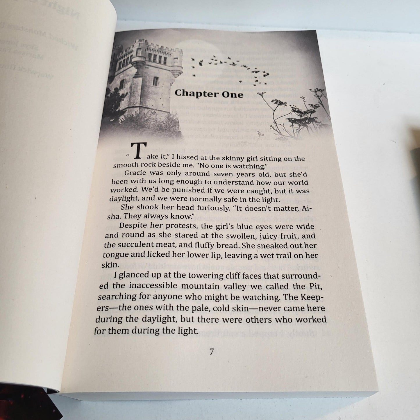 Open paperback of Wicked Monsters showing interior formatting and page one of chapter one