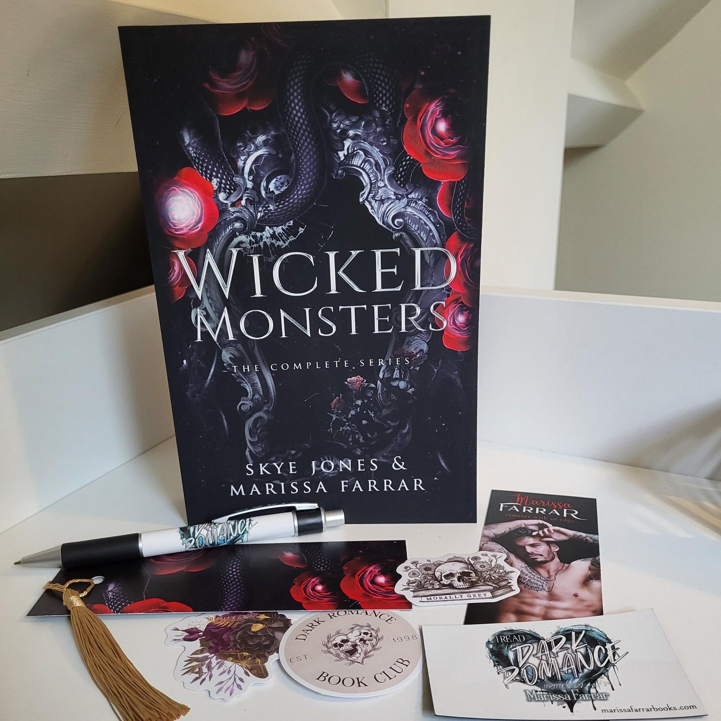 Paperback book of Wicked Monsters together with branded pen, bookmark, and stickers